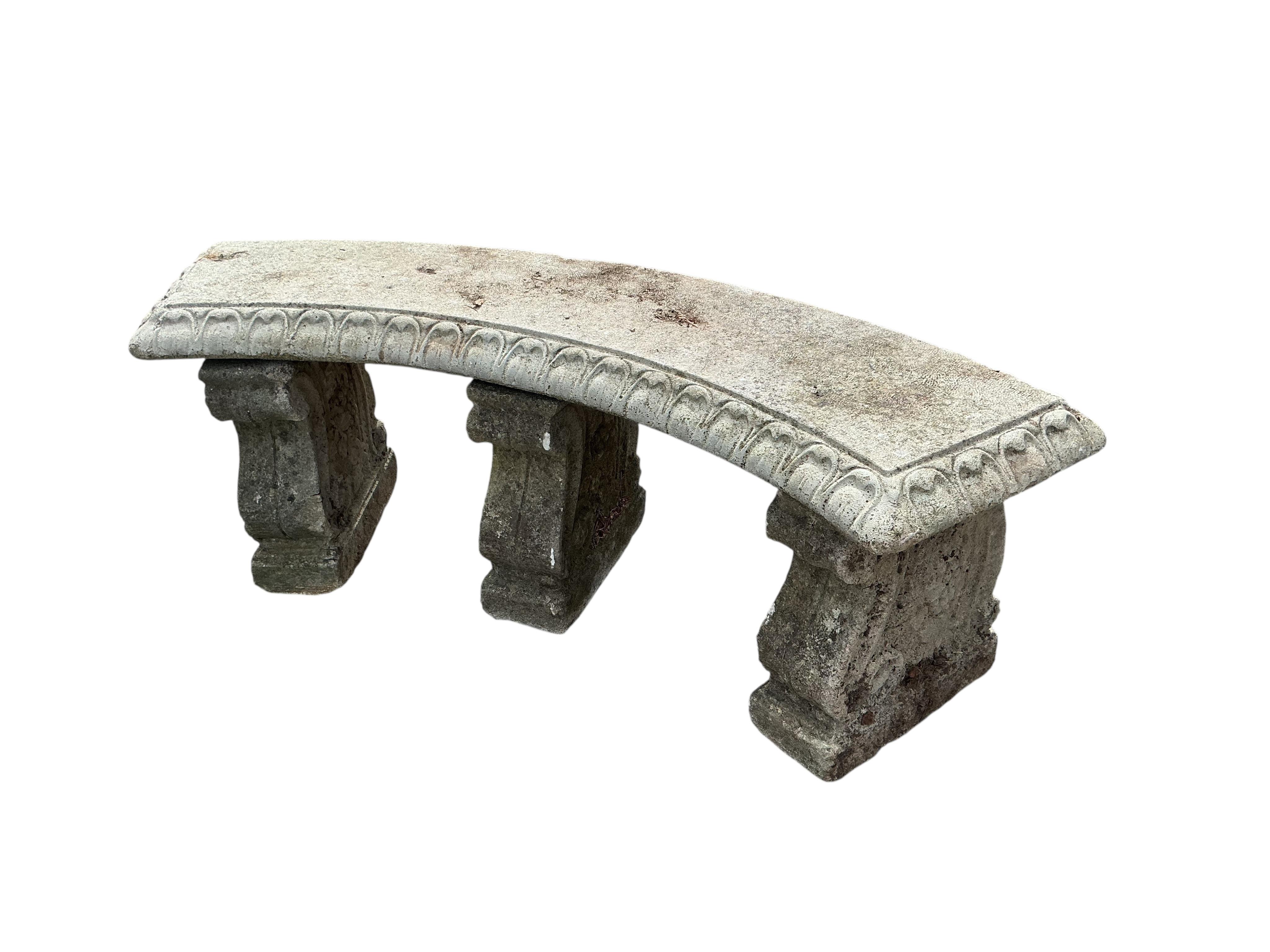 A reconstituted stone curved garden bench, width 134cm, height 44cm